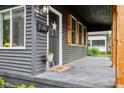 Inviting covered porch with stylish details, offering a cozy outdoor space to welcome guests and enjoy the neighborhood at 117 N Market St, Thorntown, IN 46071