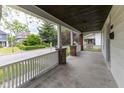 Spacious front porch with brick pillars and white railings overlooking the street at 1311 N Oakland Ave, Indianapolis, IN 46201