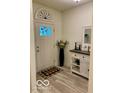 Welcoming foyer with light wood-look floors, decorative mirror, and a console table at 1349 Sunset Blvd, Avon, IN 46123