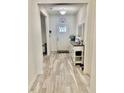 Inviting entryway featuring neutral walls, light floors, and a decorative front door with transom window detail at 1349 Sunset Blvd, Avon, IN 46123