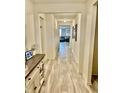 Bright hallway with light floors leading to a glimpse of the living room, showcasing the home's open layout at 1349 Sunset Blvd, Avon, IN 46123