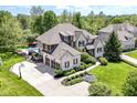 Expansive aerial view of a luxury home featuring an in-ground pool, three-car garage, and manicured grounds at 13909 Waterway Blvd, Fishers, IN 46040