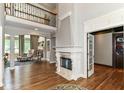 Elegant living room with a stunning fireplace, soaring ceilings, and beautiful hardwood floors at 13909 Waterway Blvd, Fishers, IN 46040