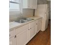 Classic kitchen featuring white cabinets and neutral countertops at 1844 N Riley Ave, Indianapolis, IN 46218