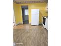 The kitchen is equipped with essential appliances, wood-style floors, and has easy access to the backyard at 208 E Madison E St, Alexandria, IN 46001