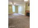 Cozy living room with neutral walls, carpet, ceiling fan and fireplace at 208 E Madison E St, Alexandria, IN 46001
