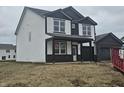 Newly constructed two-story home with a covered porch and a modern black and white color scheme at 2271 Oakmont Dr, Plainfield, IN 46168