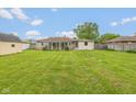 Expansive backyard with lush green grass, shed, and enclosed sunroom at 2445 S Bolton Ave, Indianapolis, IN 46203