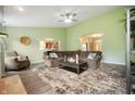 Comfortable living room showcasing a large sectional, ceiling fan, and archways to the kitchen and foyer at 2717 W Long Meadow Ln, Muncie, IN 47304