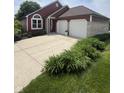 Charming single Gathering home featuring a 2 car garage, landscaped front yard, and red exterior at 3403 Island Way, Indianapolis, IN 46214