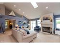 Bright living room featuring vaulted ceilings, a fireplace, and comfortable seating, creating an inviting space at 3403 Island Way, Indianapolis, IN 46214