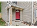 Close-up of the red front door with house number, covered porch, and neatly landscaped entrance at 3803 Churchman Woods Blvd, Indianapolis, IN 46203