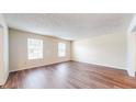 Open living area featuring wood flooring and natural light from two large windows at 3916 Jekyll Ct, Indianapolis, IN 46237
