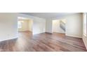 Spacious living room featuring wood flooring and ample natural light from large windows at 3916 Jekyll Ct, Indianapolis, IN 46237