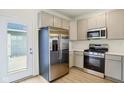 Updated kitchen with stainless steel refrigerator and gas range plus modern, light-colored cabinets at 3927 Wren Dr, Brownsburg, IN 46112