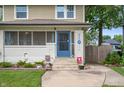 Close up front of a inviting home with a charming blue front door at 4040 Carrollton Ave, Indianapolis, IN 46205