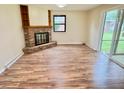 Spacious living room featuring a brick fireplace, built-in shelves, and sliding glass doors to the back patio at 5130 Navajo Ct, Columbus, IN 47203