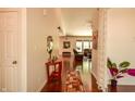 Bright hallway leads to a living room area with hardwood flooring at 6110 Pelican Ln, Columbus, IN 47201