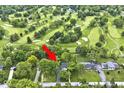 Aerial view of property adjacent to golf course showing mature trees, and surrounding neighborhood at 6115 E 65Th Pl, Indianapolis, IN 46220