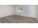 Bright room features modern gray flooring, freshly painted walls, and natural light at 625 E 106Th St, Carmel, IN 46280