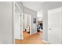 Inviting hallway with neutral paint, wood floors, and views into the living spaces at 7312 Drum Castle Ct, Indianapolis, IN 46259
