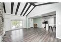 Open-concept living area showcases wood floors, and provides a seamless transition into the updated kitchen at 7414 Mendenhall Rd, Camby, IN 46113