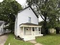 Traditional two-story home surrounded by mature trees and greenery at 745 N Tremont St, Indianapolis, IN 46222