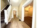 Inviting foyer with staircase, wood flooring and neutral color palette at 745 N Tremont St, Indianapolis, IN 46222