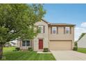 Attractive two-story home with brick and vinyl siding, complimented by a well-manicured lawn and landscaping at 764 Port Dr, Avon, IN 46123
