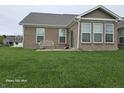 Well-maintained backyard with a patio seating area and a lush green lawn at 9106 Hedley E Way, Avon, IN 46123