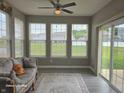 Comfortable sunroom with a ceiling fan, many windows, and a sliding glass door at 9106 Hedley E Way, Avon, IN 46123