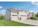 This home boasts an expansive driveway leading to a three-car garage, showcasing ample parking at 9656 Summerton Dr, Fishers, IN 46037
