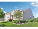 A well-manicured lawn and landscaping surround this home's exterior, accentuating the attractive architecture at 9656 Summerton Dr, Fishers, IN 46037