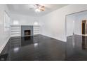 Spacious living room features gleaming dark hardwood floors, fireplace, built-in shelves, and ample natural light at 1065 36Th St, Indianapolis, IN 46208