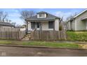 Charming home featuring a fenced yard, neutral paint and inviting curb appeal at 1216 N Ewing St, Indianapolis, IN 46201