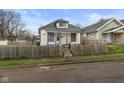 Charming home featuring a fenced yard, neutral paint and inviting curb appeal at 1216 N Ewing St, Indianapolis, IN 46201