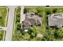 Stunning aerial shot of a house featuring a detailed roof, manicured lawn, and surrounding trees at 14020 Brookstone Dr, Carmel, IN 46032