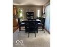 Cozy dining area features a stylish table set and natural light from the nearby windows at 1425 Winding Trail Cir, Greenwood, IN 46142
