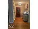Inviting entryway boasts hardwood floors, built-in shelving, and decorative accents at 1425 Winding Trail Cir, Greenwood, IN 46142