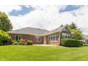 Expansive backyard featuring lush green grass and a brick exterior of the home at 1589 Belleflower Ct, Avon, IN 46123