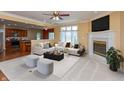 Bright living room featuring plush seating, fireplace, and open-concept layout with a view to the kitchen at 1589 Belleflower Ct, Avon, IN 46123