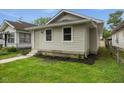 Charming home featuring fresh landscaping and a well-maintained yard at 1606 Asbury St, Indianapolis, IN 46203