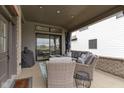 Cozy covered porch with ample seating, a grill, and seamless access to the home's interior through sliding doors at 17359 Wilkes Way, Westfield, IN 46074