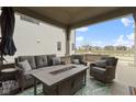 Inviting covered porch with stylish seating, a fire table, and ample space for outdoor relaxation and entertainment at 17359 Wilkes Way, Westfield, IN 46074
