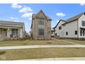 Charming two-story home featuring a manicured lawn, brick and siding exterior, and inviting curb appeal at 17359 Wilkes Way, Westfield, IN 46074