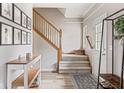 Welcoming foyer with hardwood floors, staircase, and stylish decor at 18278 Benton Oak Dr, Noblesville, IN 46062