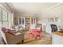 Bright playroom with hardwood floors, built-in shelving, and a cozy seating area at 18278 Benton Oak Dr, Noblesville, IN 46062