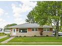 Charming single story house with nicely maintained lawn and stone with brick accenting the facade at 2110 Allison Ave, Speedway, IN 46224