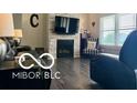 Living room with fireplace, accent chair and modern flooring at 217 N Liberty Blvd, Mooresville, IN 46158
