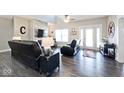 Spacious living room with a modern fireplace, stylish decor, and wood flooring at 217 N Liberty Blvd, Mooresville, IN 46158